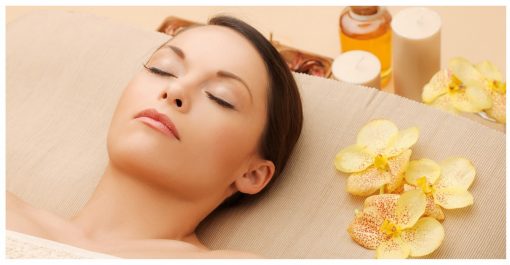woman having facial or body massage in spa salon